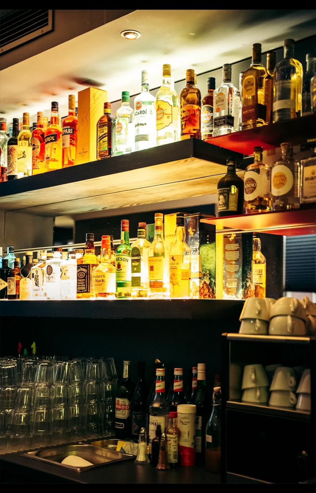 Beleuchtetes Flaschenregal hinter der Bar